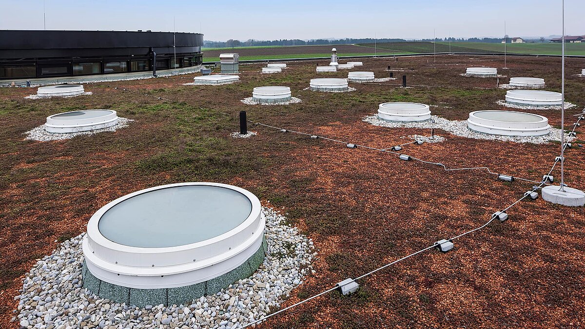 Green roof at Zaltech in Moosdorf, Austria, with several round LAMILUX flat roof windows FE.