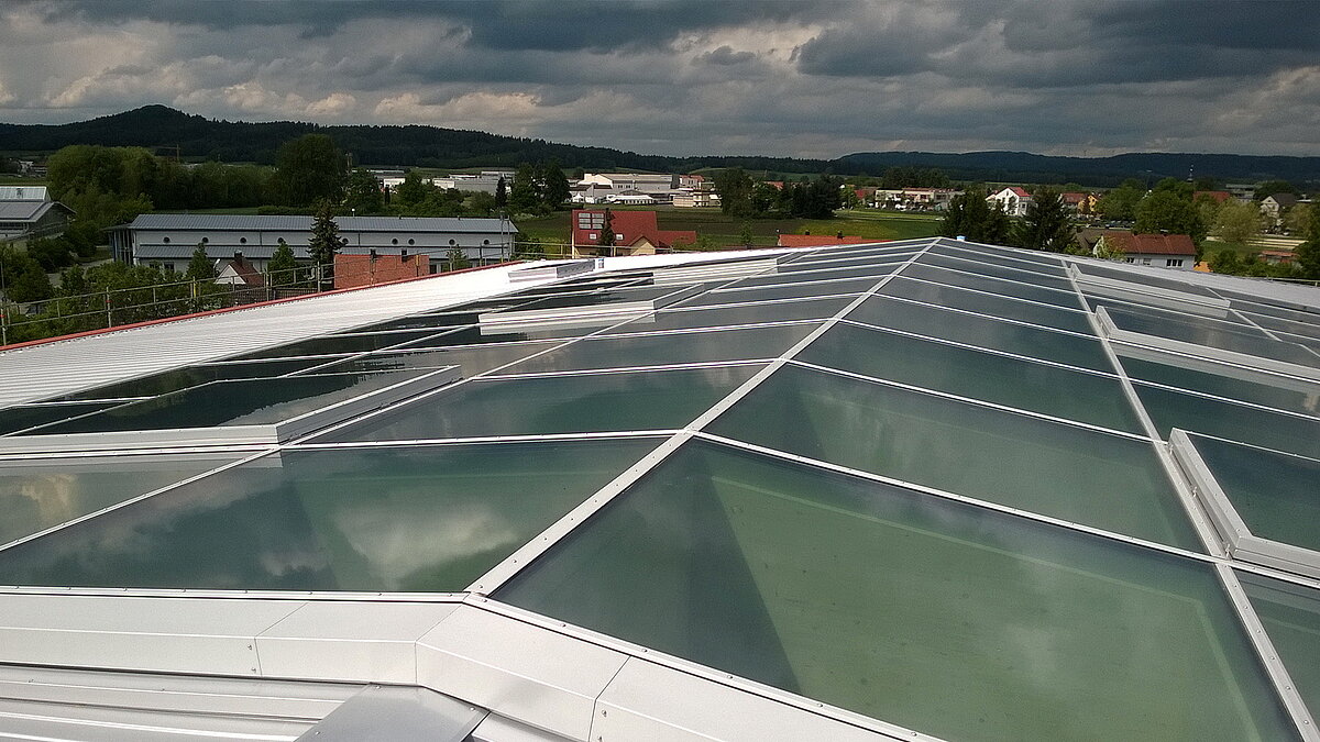 Glass roof of the Willibald-Gluck-Gymnasium in Neumarkt with a view of the surrounding landscape.