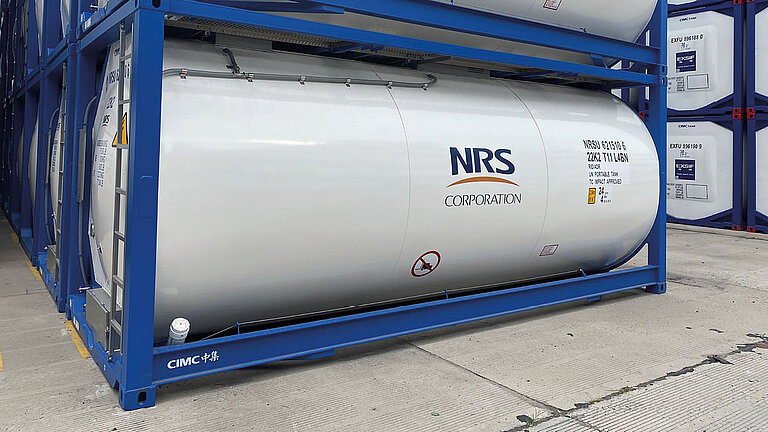 White ISO tank container labeled "NRS CORPORATION" with GRP tank cladding