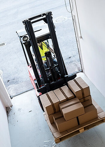 Forklift transporting boxes on a pallet.