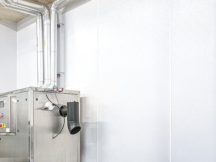 LAMILUX Composites Wall Cladding hygienic wall in bakery with stainless steel machine and ventilation pipes