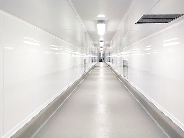 Long, well-lit, white corridor